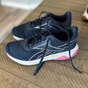 Used and well worn women’s Reebok training sneakers, size 6.5